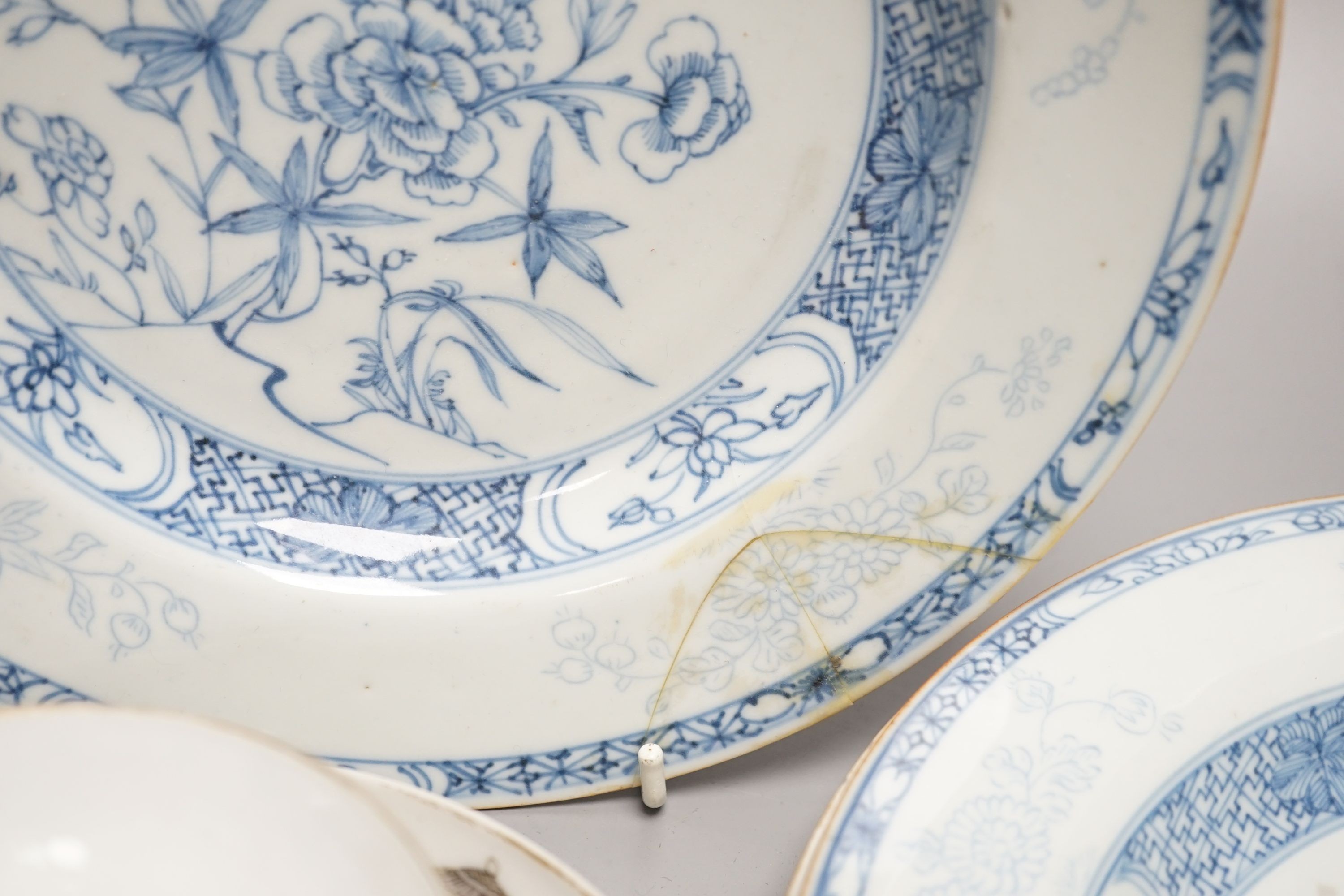 A 19th century Chinese famille rose bowl and saucer, a blue and white tea bowl on stand, a hardstone carving and three 18th century blue and white plates